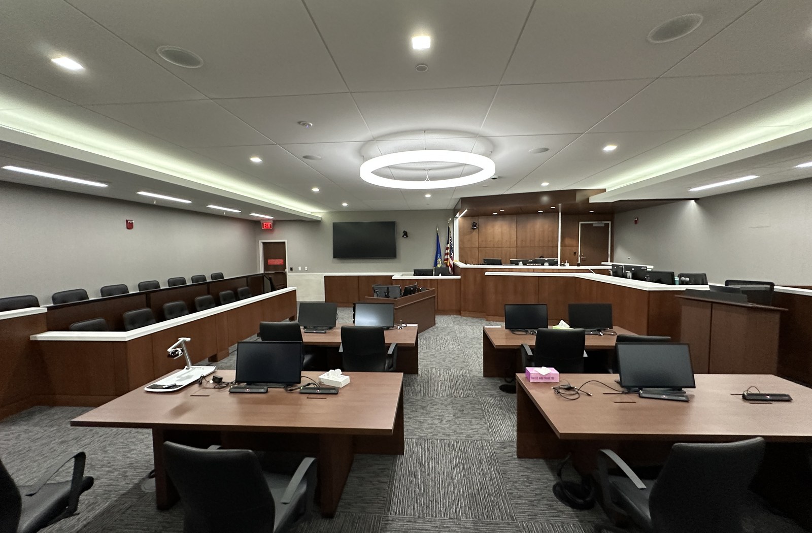 Courtroom with integrated displays, microphones, evidence presentation, and conferencing technology